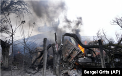 Smoke rises from an air-defense base in the aftermath of an apparent Russian strike in Mariupol on February 24.