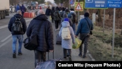 Ukrainians fleeing the violence in their homeland cross the border into Romania on Ferbuary 25. 