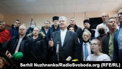 Surrounded by supporters, former Ukrainian President Petro Poroshenko (center) speaks at the Kyiv District Court last month. 