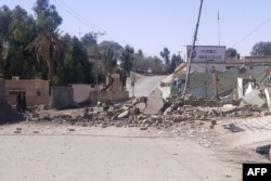 Security personnel stand by the checkpost destroyed in overnight attacks by militants in the Nauski district of Balochistan Province on February 3.