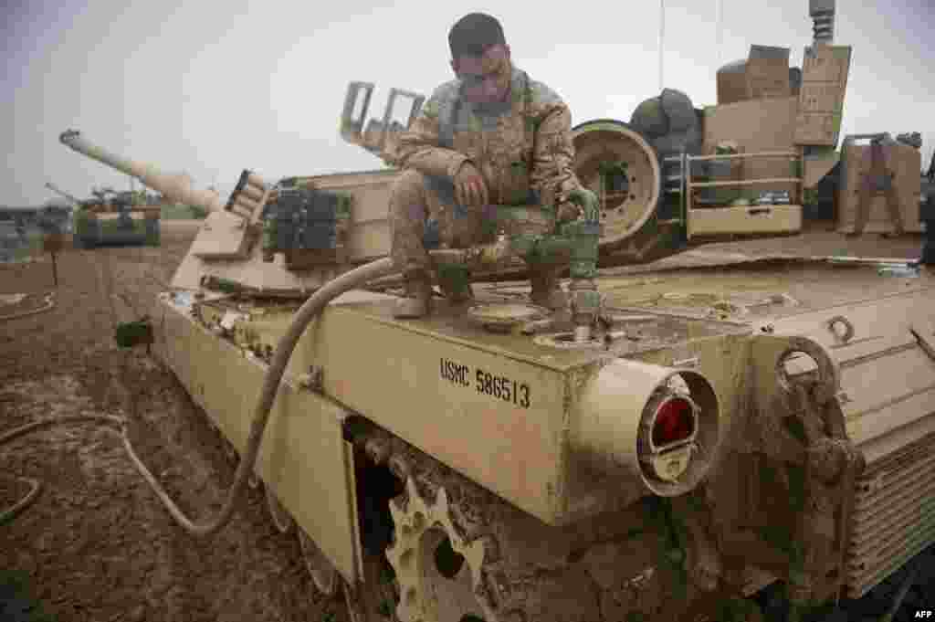 A U.S. Marine refuels his M1 Abrams tank at FOB Edinburgh in Helmand Province, Afghanistan on February 2, 2011. The current M1A2 Abrams can reach a top speed of 72 km/h (on paved roads) and 48 km/h&nbsp;off-road. The engine can use a variety of fuels, including jet fuel, gasoline, diesel, and marine diesel. &nbsp;