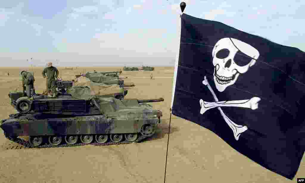 U.S. Marine Corps reservists fly their &quot;Jolly Roger&quot; on an M1A1 Abrams tank at U.S. Marine Corps Camp Grizzly in Kuwait on February 16, 2003. The Abrams has gone through various upgrades, resulting in the M1, M1A1, and M1A2 versions, with each having improvements in armament, protection, and electronics. &nbsp;