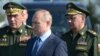 Russian President Vladimir Putin (center) visits a flight-test center in the Astrakhan region in 2019 with Chief of the General Staff Valery Gerasimov (left) and Defense Minister Sergei Shoigu.