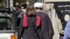 A woman walks without a head scarf in the heart of the Iranian capital, Tehran, on October 11.