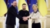 Ukrainian President Volodymyr Zelenskiy (center) European Commission President Ursula von der Leyen (right) and European Council President Charles Michel shake hands during their EU-Ukraine summit in Kyiv on February 3. 