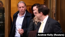 Charles McGonigal (left) exits Manhattan federal court after being arrested on charges for violating U.S. sanctions on Russia in New York City on January 23.