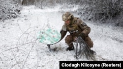 A Ukrainian soldier disconnects a Starlink terminal near the front line in eastern Ukraine.