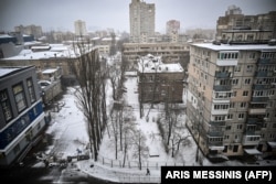 A man walks on the snow-covered pavement in an empty street of Kyiv a week after Russia launched its invasion of Ukraine in February.