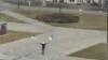 Defiant Citizen Waves Ukrainian Flag In Front Of Russian Tanks GRAB 2