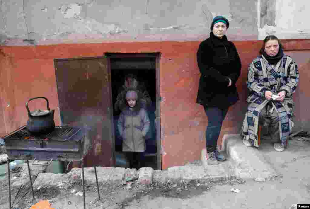 People seek refuge in the basement of a building.