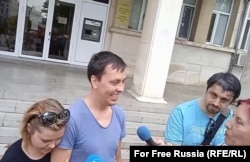 Alchin, accompanied by his wife, addresses reporters outside the courthouse following his release.