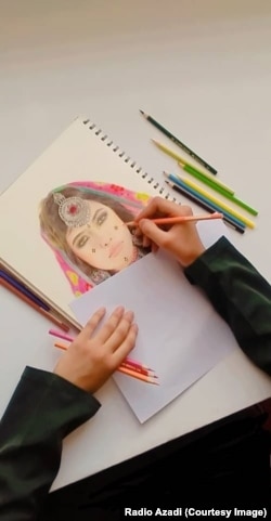 Saahida pictured drawing at home