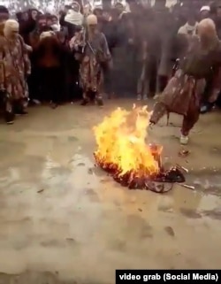 Taliban fighters burning musical instruments in the Zazai Aryub district of Paktia Province. (video grab)