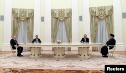 Putin (left) attends a meeting with Raisi in Moscow on January 19, 2022.