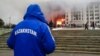 Protesters rally on January 5 outside the Almaty mayor’s office, which was on fire.