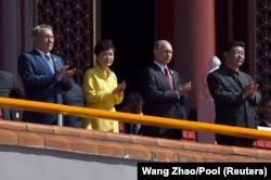 Former Kazakh President Nursultan Nazarbaev (left) stands with Russian President Vladimir Putin (second from right) and Chinese President Xi Jinping (right) at a military parade in Beijing in 2015 in Beijing.