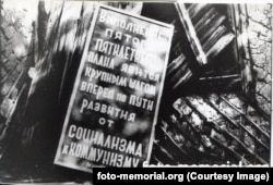 A sign at an abandoned labor camp on Stalin's abortive Transpolar Mainline railway project. The sign reads, "Implementation of the fifth five-year plan will be a major step forward toward developing from socialism to communism."