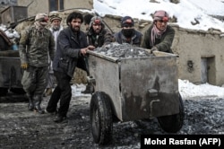 Afghan workers push a cart filled with stones at an emerald mine in Panjshir Province's Mikeni Valley. (file photo)