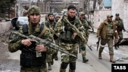 Men from Chechnya's Akhmat Volunteer Battalion patrol the Mariupol Iron and Steelworks after its capture from the Ukrainian Army.