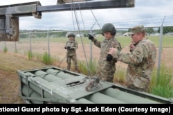 An HIMARS rocket pod being loaded in Wyoming