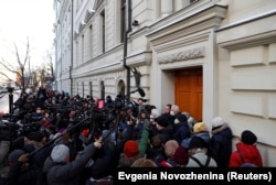 Supporters and journalists gather outside a court building after a hearing of the Russian Supreme Court on the closure of Memorial, in Moscow on December 28, 2021.