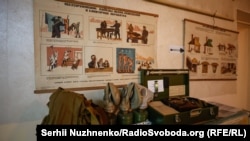 Signage and gas masks at the entrance to a bunker designed for residents of apartments in eastern Kyiv.