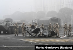 Troops are seen at the main square where hundreds of people were protesting against the government in Almaty on January 6.