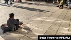 A man from Kosovo's Roma community asks passersby for money on the main square in Pristina. (file photo)