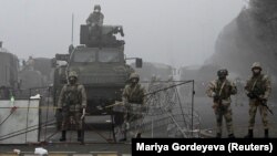 Troops are seen in Almaty's main square where hundreds of people were protesting against the government after the Kazakh authorities' decision to lift price caps on liquefied petroleum gas.