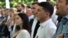 Ukrainian President Volodymyr Zelensky (second right) and participants sing the national anthem during his Servant of the People party's conference before the recent parliamentary elections. Many of the candidates chosen at this event will now be entering parliament for the first time. 