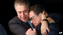 Siamak Namazi (right) is embraced by a relative upon returning to the United States last year after being imprisoned in Iran for eight years. 