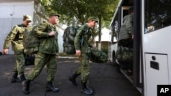 Russian recruits take a bus near a military recruitment center in Krasnodar, Russia. President Vladimir Putin has eased the paperwork and offered other incentives to swell the ranks of his military forces with foreigners.