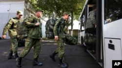 Recruits take a bus near a military recruitment center in Krasnodar, Russia. Human rights defenders say they have been inundated with pleas for help from thousands of migrants who have mistakenly enrolled in the Russian Army or been pressured to do so.