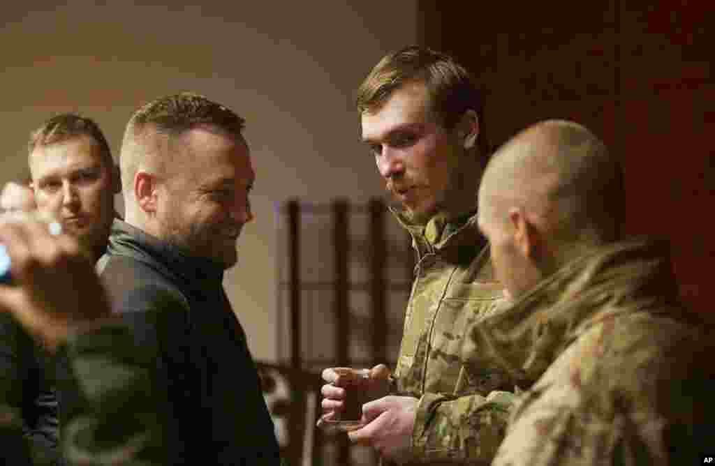 Ukrainian Interior Minister Denys Monastyrsky (second from left), greets Azov regiment commander Denys Prokopenko (second from right), who was released in the prisoner exchange in Chernihiv.