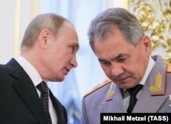 Russian President Vladimir Putin (left) and Defense Minister Sergei Shoigu (file photo)