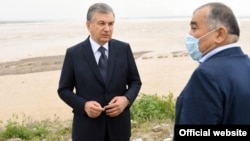 After the May 1 collapse of the dam, Uzbek President Shavkat Mirziyoev (left) was accompanied at the scene by a wealthy senator, Abdughani Sanginov, who was involved in the construction of the project. 