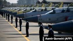 Pakistani Air Force personnel stand guard in front of 14 JF-17B multirole aircraft at a ceremony in 2020.