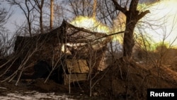 Ukrainian soldiers fire a self-propelled howitzer toward Russian troops on the a front line near the town of Chasiv Yar in Ukraine's eastern Donetsk region. 