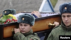 Russian servicemen carry the coffin of Vadim Kostenko at his funeral in the village of Grechnaya Balka on October 28.