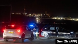 Israeli security forces secure the area at the site of a drone strike near the northern Israeli town of Binyamina on October 13.