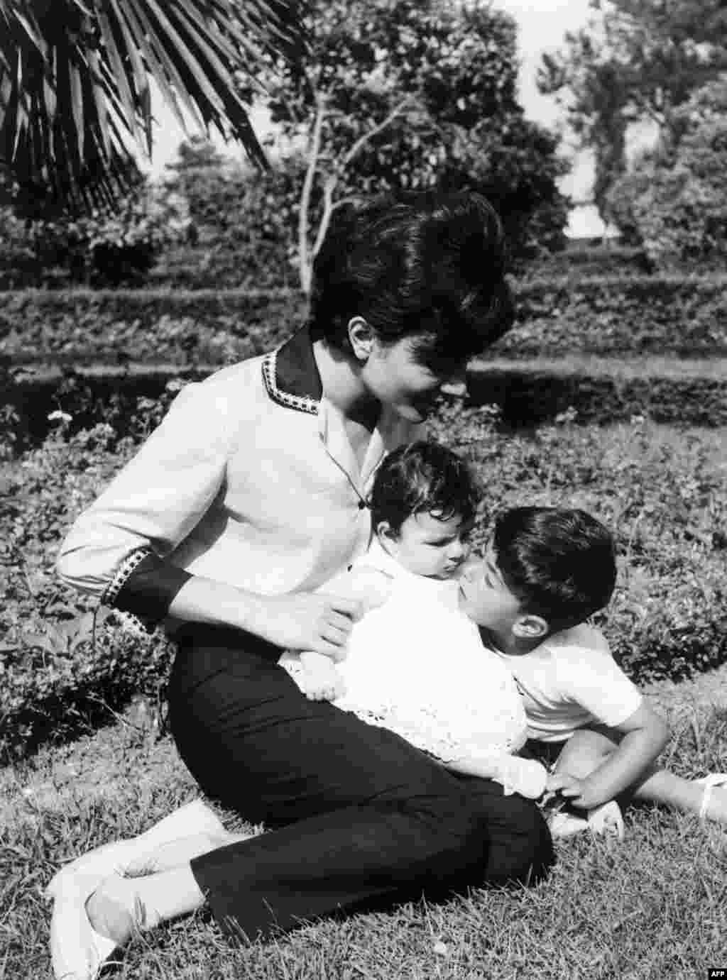 Empress Farah with her children, Prince Raza and Princess Farahnaz, in Tehran in 1963.