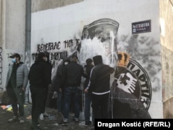 Within about an hour, half a dozen or so men who didn't want to identify themselves showed up at the scene to try and scrub the white paint off the mural.