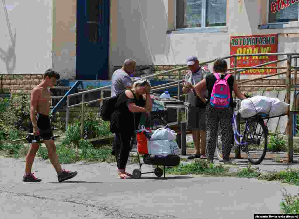 Residents of Lysychansk wait with their belongings to be evacuated from the destroyed city.&nbsp;