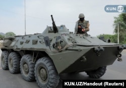 An Uzbek soldier guards a street in Nukus, capital of the northwestern Karakalpakstan region, on July 3.