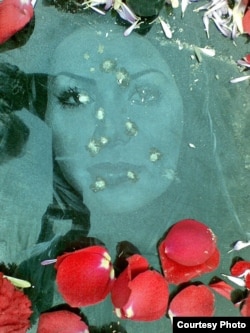 The bullet-riddled gravestone of Neda Aqa Soltan, a young protester whose death during anti-government demonstrations in 2009 sparked international outrage. (file photo)