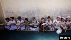 Afghan boys read the Koran at a madrasah in Kabul.