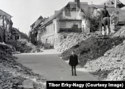 A boy poses among the rubble of Budapest's castle district.