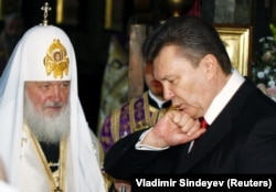 Then-President-elect Viktor Yanukovych kisses his ring during a religious service led by Patriarch Kirill, the head of the Russian Orthodox Church, at the Kyiv-Pechersk Lavra in February 2010.