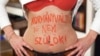 A photo from Zsuzsanna Simon's series, in which women wrote "I will not give birth until there's a change in government" -- or something similar -- on their bodies.
