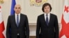 Council of Europe Secretary-General Alain Berset (left) and Georgian Prime Minister Irakli Kobakhidze pose for a photo during their meeting in Tbilisi on December 18.